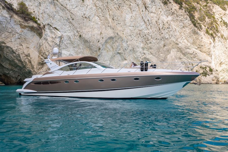 High-speed motor yacht cutting through crystal-clear waters.