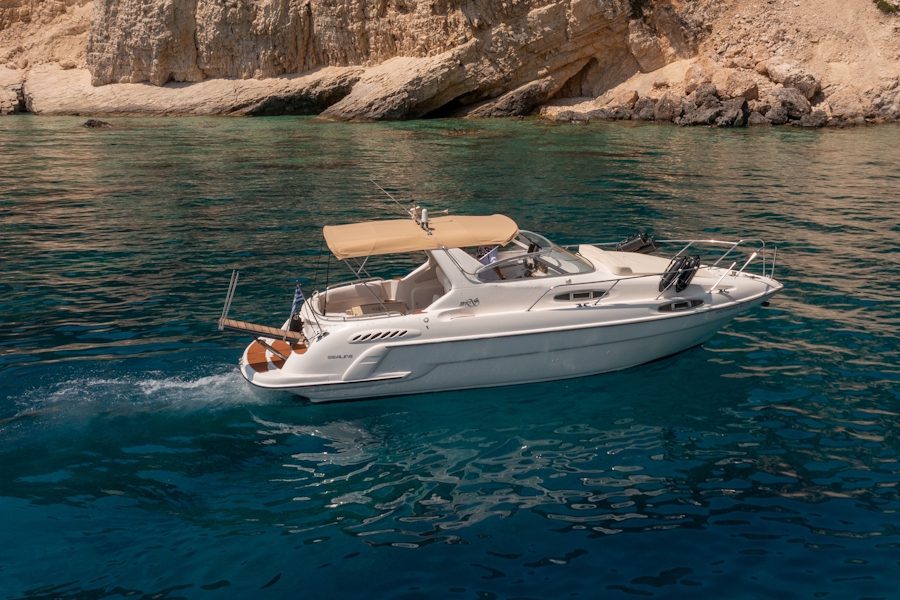 Luxury yacht anchored in a secluded bay in Greece.